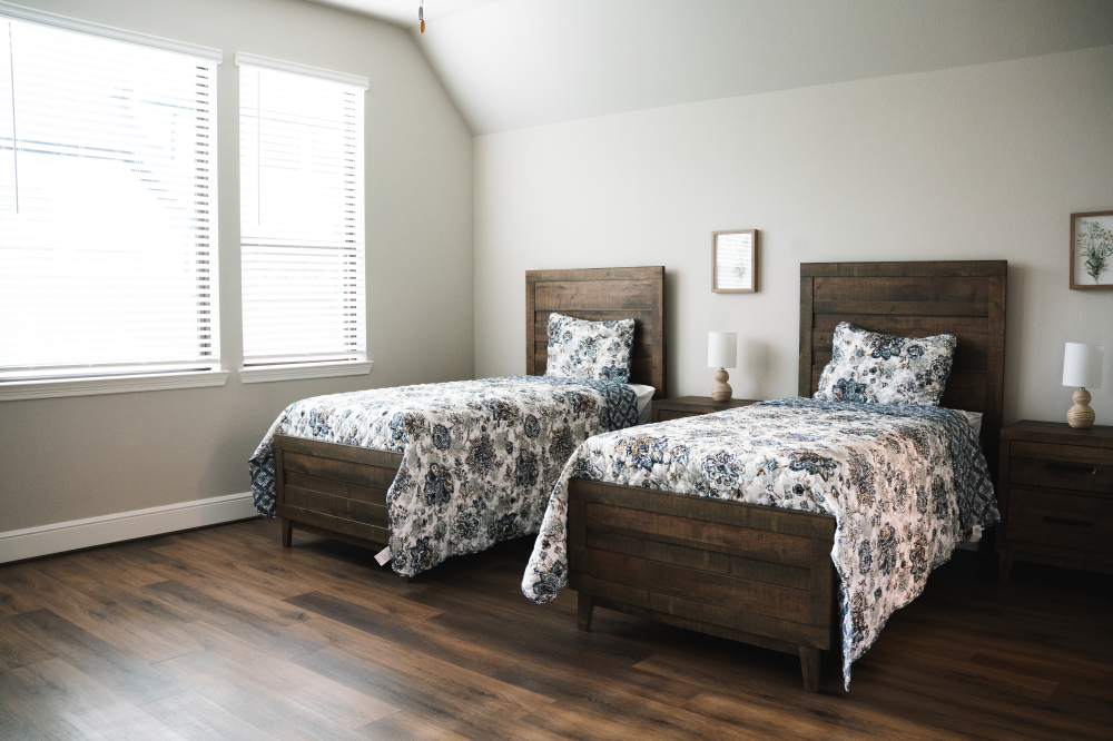 Shared bedroom with two beds at Providence Assisted Living Solutions in Fulshear, Texas